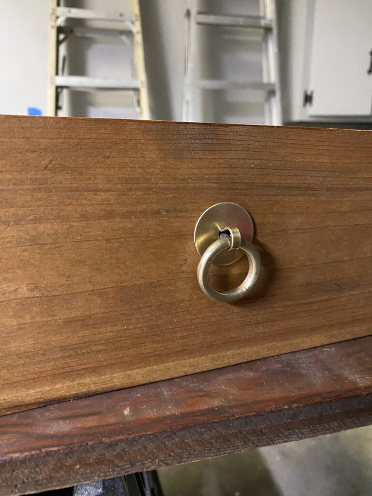 restored gold drawer pull installed